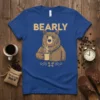 Bearly text with a brown bear holding a coffee mug on a blue t-shirt design