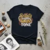 T-shirt with the text "Beauty has no SKIN TONE" in gold glitter and white font, with abstract brown and gold