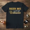 BEER ME i just Got ENGAGED text with a beer mug graphic on a black t-shirt, celebrating an engagement