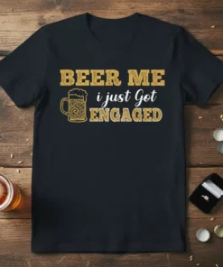BEER ME i just Got ENGAGED text with a beer mug graphic on a black t-shirt, celebrating an engagement