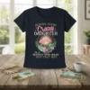 Text "Behind Every Crazy Daughter Is A Mother Who Made Her That Way" with flamingos and tropical leaves graphic on