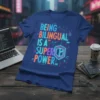 Blue t-shirt with neon text "Being Bilingual Is A Super Power" in a circuit board design, primary keyword included