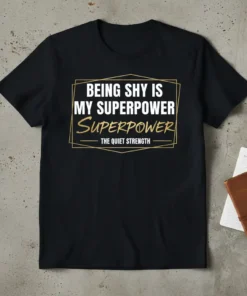 Being Shy Is My Superpower The Quiet Strength quote on a black t-shirt, white and gold text, graphic design