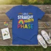 T-shirt with the text "Being STRAIGHT was my PHASE" in colorful, bold lettering and rainbow flag graphics