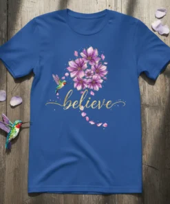 Blue t-shirt with the word "believe" in gold script, a hummingbird, and purple flowers