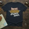 Navy t-shirt with "best BACKSEAT driver ever" text in distressed white and yellow lettering, framed by a vintage license plate