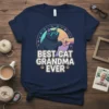Best Cat Grandma Ever t-shirt design with a black cat wearing sunglasses giving a fist bump. Paw prints flank the