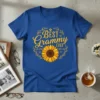 Blue t-shirt with yellow "BEST Grammy EVER" text and a sunflower graphic, surrounded by a laurel wreath