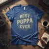 Blue t-shirt with "Best Poppa Ever" text in distressed vintage font, surrounded by tool graphics