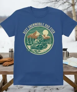Best Snowmobile Dad Ever text with vintage snowmobile and mountain graphic on a blue t-shirt