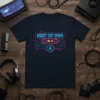 Retro cassette tape design with "BEST OF 1984" text in neon blue and purple, on a navy blue t-shirt