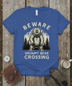 BEWARE GRUMPY BEAR CROSSING text with a roaring bear and mountain graphic on a blue t-shirt