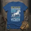 Beware I Ride Horses quote t-shirt with a white horse graphic and pitchforks, featuring farm-themed text and a distressed look