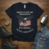 Dark t-shirt with "Biden Is Not My President! Just Kidding. I'm Not A Whiny Bitch." text and an eagle over