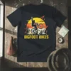 Bigfoot riding a mountain bike with the text Bigfoot Bikes, featuring a retro sunset and mountains