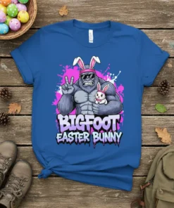 Bigfoot wearing bunny ears and holding a baby bunny, with text "BIGFOOT EASTER BUNNY" on a blue t-shirt