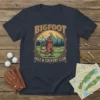 Bigfoot Golf & Country Club t-shirt design featuring Bigfoot swinging a golf club with a golf cart and mountains in