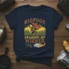 BIGFOOT GRABBED MY WIENER t-shirt design with Bigfoot holding a hot dog, mountains, and grilling elements