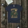 Bigfoot Hide and Seek World Champion t-shirt design with Bigfoot graphic and text, set against a forest backdrop