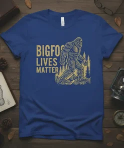 Bigfoot Lives Matter text with a Bigfoot graphic and forest illustration on a blue t-shirt