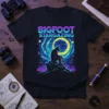 Bigfoot Stargazing graphic t-shirt design with Bigfoot silhouette looking at a swirling galaxy and moon
