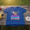 Birth Day DUDE t-shirt with a sloth hanging and neon text, featuring colorful birthday lights and confetti