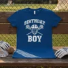 Birthday Boy lacrosse t-shirt with helmet and crossed sticks graphic in white on a royal blue shirt