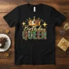 Birthday Queen text with a golden crown and colorful gem accents on a black t-shirt