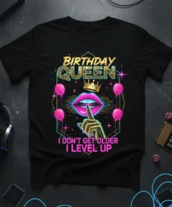 Birthday Queen graphic tee with "I Don't Get Older I Level Up" text, pink lips, crown, and balloons