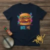 Bite Me text in neon colors below a detailed hamburger graphic on a navy t-shirt
