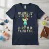 Navy blue t-shirt with "Blame It On The Drink Package" text and a tropical cocktail graphic