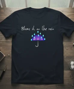 T-shirt with "Blame it on the rain" text and a purple umbrella with blue raindrops graphic