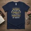 Blessed by God Spoiled by Husband Protected by Both quote on a navy blue t-shirt with floral accents