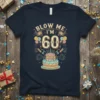 Blow Me I'm 60 birthday t-shirt with a cake, balloons, and fireworks graphic