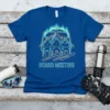 Blue t-shirt with "Board Meeting" text and graphic of three skiers on a ski lift, vibrant green aurora borealis in