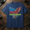 Bold Badass Superhuman That's Just Who I Am quote with a phoenix graphic and lightning accents on a navy t-shirt
