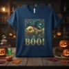 Boo Fish Halloween T-Shirt design with a fish wearing a witch hat and the text "BOO!" in golden lettering