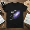 Black t-shirt with white text "BOOP" above a white cat touching a colorful galaxy graphic