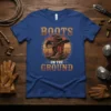 Boots On The Ground T-Shirt with cowboy boots and hat graphic, vintage sunset background