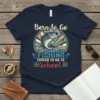 Born to Go Fishing Forced to Go to School t-shirt with a jumping bass graphic and retro sunburst background