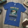 Born to Go Fishing Forced to Go to School t-shirt featuring a jumping bass, fishing rods, sunset, books, and pencils