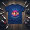 Bowl Movements text with a retro sunset and bowling graphic on a navy blue t-shirt