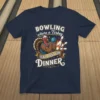 Bowling where a Turkey ISN'T JUST FOR DINNER text on a navy t-shirt with a muscular cartoon turkey holding a