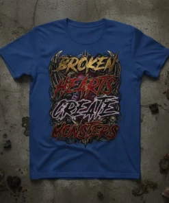 Broken Hearts Create Monsters text design with gothic font and skull graphics on a blue t-shirt
