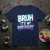 Bruh It's My Birthday text design with graffiti-style font and colorful accents on a navy blue t-shirt