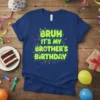 Bruh It's My Brother's Birthday text design with colorful confetti and birthday cakes on a navy t-shirt