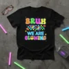 Bruh We Are Glowing text with retro sunglasses and smiley face on a black t-shirt, vibrant colors, 90s theme