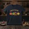Burger Anatomy t-shirt design showing labeled ingredients like bun, tomato, cheese, and patty