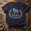 Navy t-shirt with gold text "but now I'm found" and a detailed illustration of a sheep within a laurel wreath