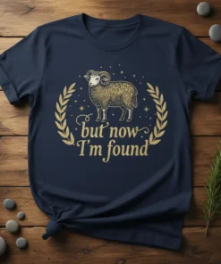 Navy t-shirt with gold text "but now I'm found" and a detailed illustration of a sheep within a laurel wreath